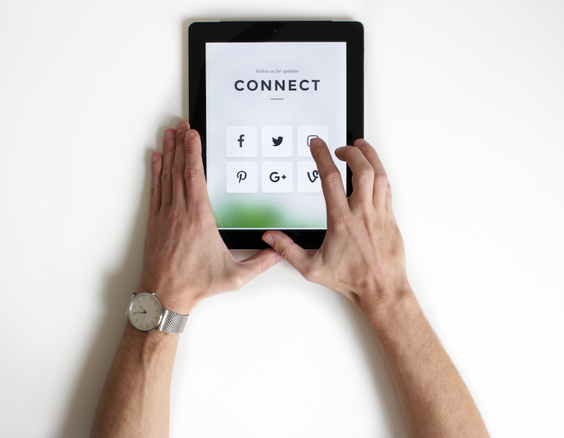 Picture of man using a tablet to connect on social media