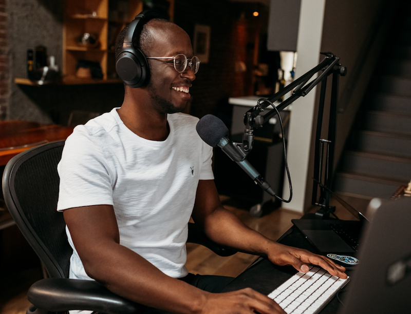 Image of podcaster talking on a microphone